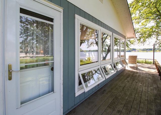 wooden terrace featuring a water view