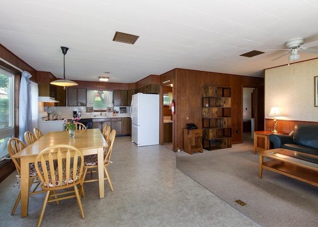 dining room featuring wood walls