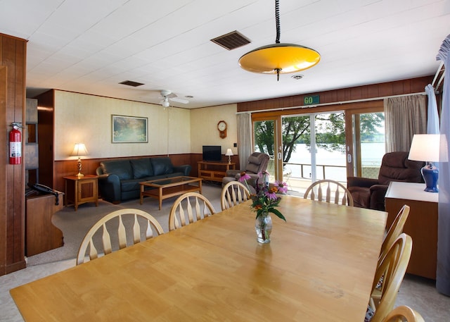 carpeted dining room featuring ceiling fan