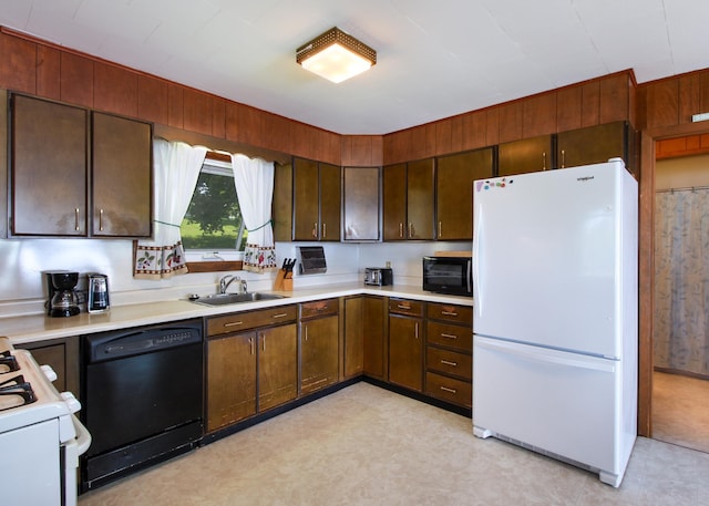 kitchen with dark brown cabinetry, sink, and black appliances