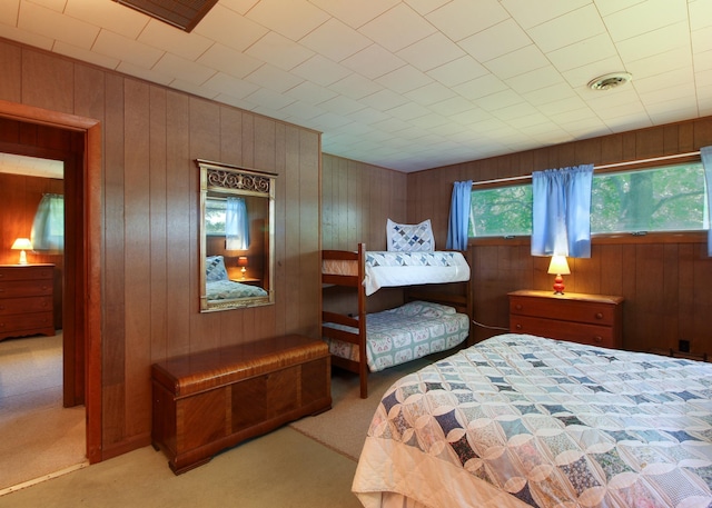 carpeted bedroom with wooden walls