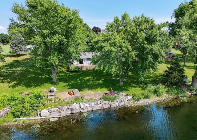 view of property's community with a lawn and a water view