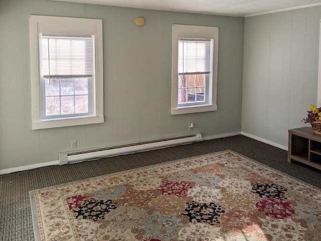 unfurnished room with a baseboard radiator, dark colored carpet, and plenty of natural light