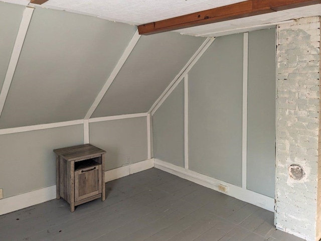 additional living space featuring hardwood / wood-style floors