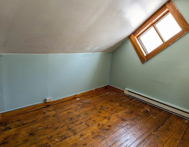 bonus room featuring a baseboard radiator, dark hardwood / wood-style flooring, and vaulted ceiling