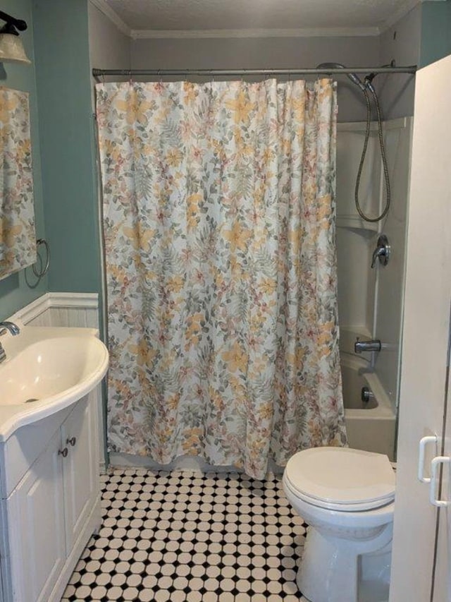 bathroom with ornamental molding, toilet, and vanity