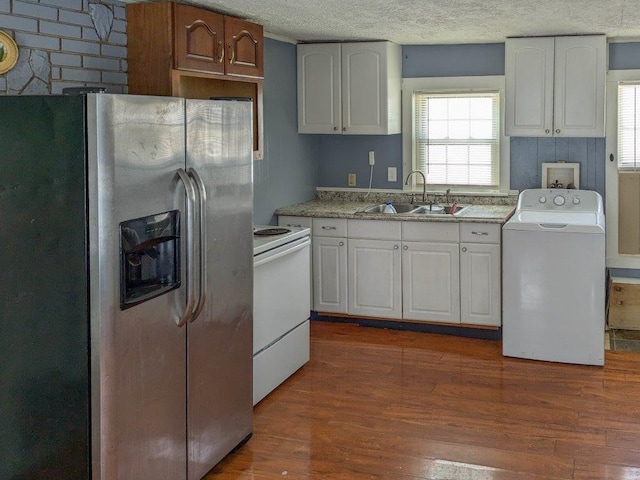 kitchen with sink, stainless steel fridge, electric range, white cabinets, and washer / dryer