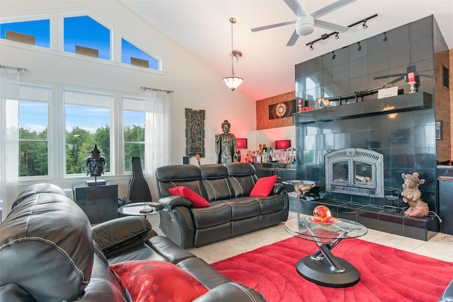 living room featuring lofted ceiling, light tile patterned floors, rail lighting, and ceiling fan