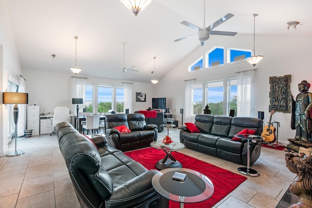 living room featuring ceiling fan, light tile patterned floors, high vaulted ceiling, and a healthy amount of sunlight