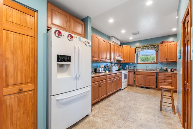 kitchen with sink, a wall mounted AC, and white appliances