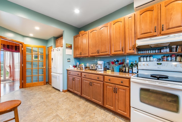 kitchen with white appliances and an AC wall unit