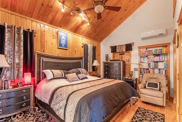 bedroom featuring wood walls, a wall mounted air conditioner, vaulted ceiling, light wood-type flooring, and wooden ceiling