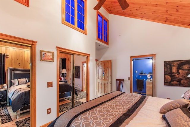 bedroom with high vaulted ceiling, wood ceiling, and a closet