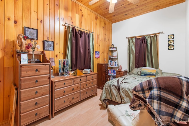 bedroom with wood ceiling, light hardwood / wood-style flooring, and wood walls