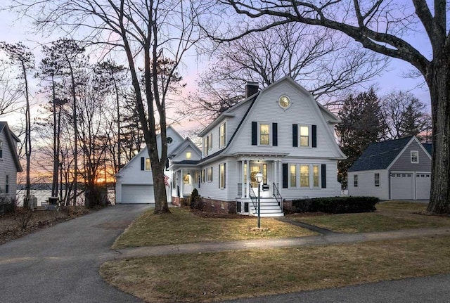 44 Winnicoash St, Laconia, NH 03246 - view of front facade with a garage, an outbuilding, and a lawn