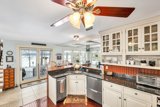 44 Winnicoash St, Laconia, NH 03246 - kitchen with stainless steel dishwasher, dark stone countertops, kitchen peninsula, and white cabinets