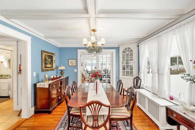 44 Winnicoash St, Laconia, NH 03246 - dining area with a notable chandelier, beam ceiling, ornamental molding, and light hardwood / wood-style floors