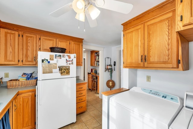 44 Winnicoash St, Laconia, NH 03246 - kitchen with washer and dryer, ceiling fan, white fridge, and light tile patterned floors