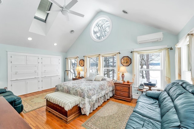 44 Winnicoash St, Laconia, NH 03246 - bedroom with multiple windows, a wall mounted air conditioner, light hardwood / wood-style floors, and high vaulted ceiling