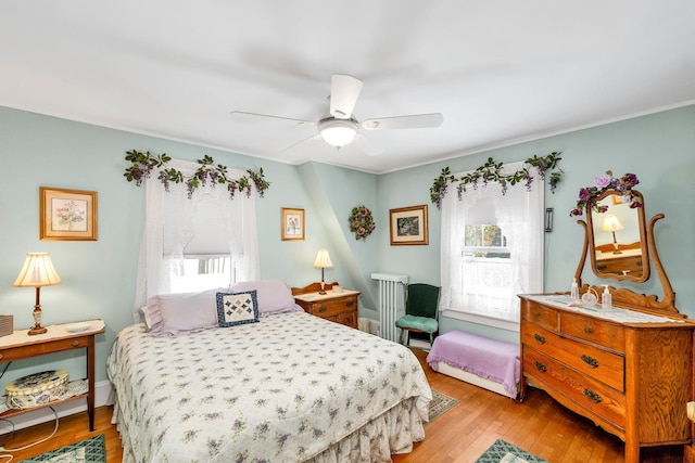 44 Winnicoash St, Laconia, NH 03246 - bedroom with ceiling fan, radiator, and light wood-type flooring