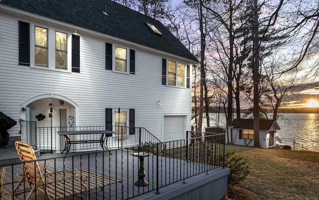 44 Winnicoash St, Laconia, NH 03246 - back house at dusk featuring a water view, a garage, and a shed