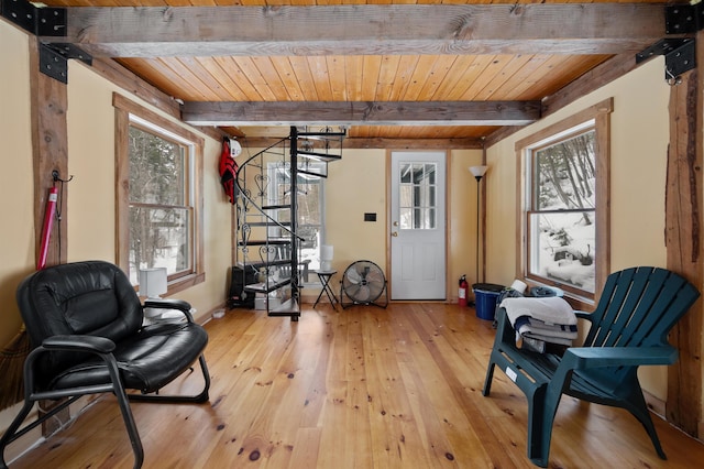 living area with beamed ceiling, light hardwood / wood-style flooring, and wooden ceiling