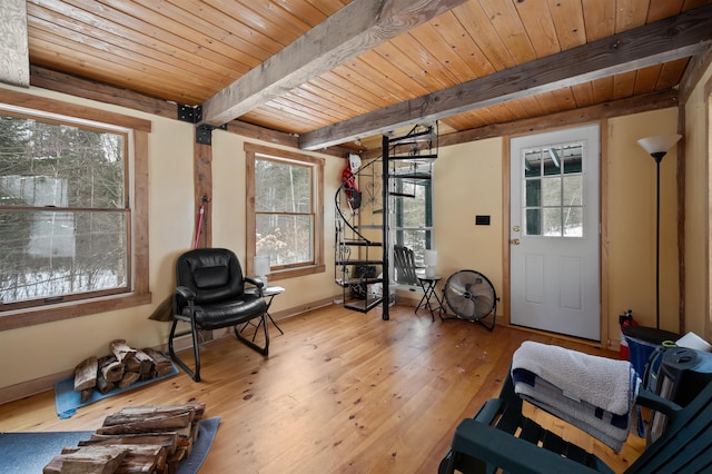 sitting room with hardwood / wood-style floors, a wealth of natural light, wooden ceiling, and beamed ceiling