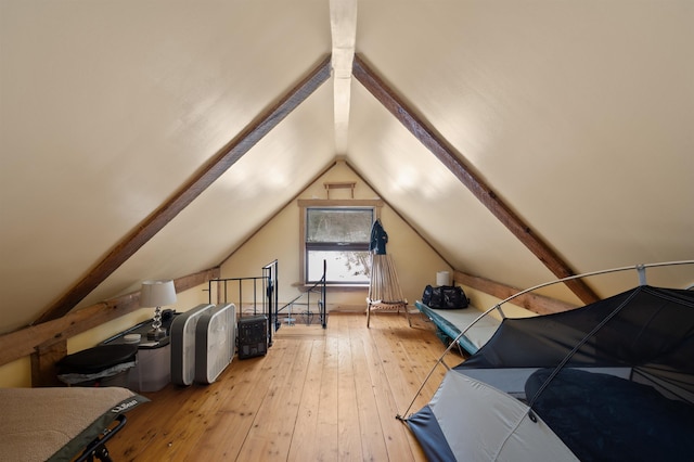 additional living space featuring lofted ceiling and hardwood / wood-style floors