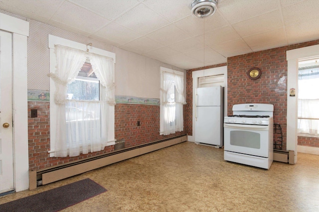 kitchen with white appliances, brick wall, a paneled ceiling, and a baseboard heating unit