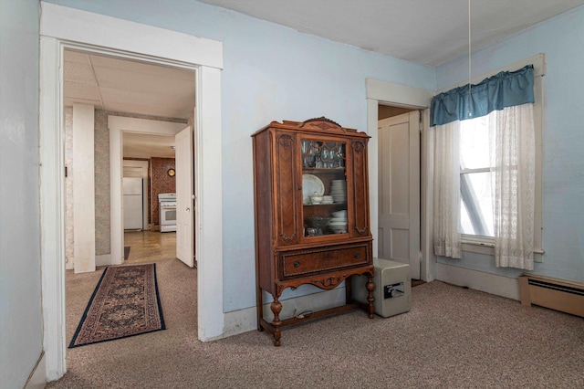 interior space with carpet and baseboard heating