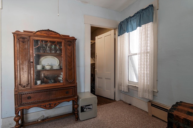 interior space with carpet flooring and baseboard heating