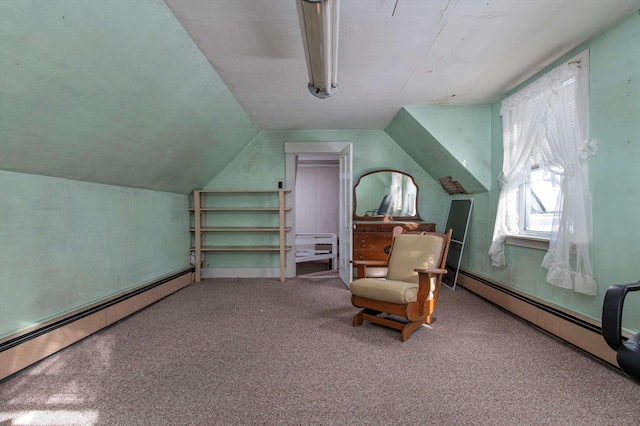 living area with vaulted ceiling, a baseboard heating unit, and carpet flooring