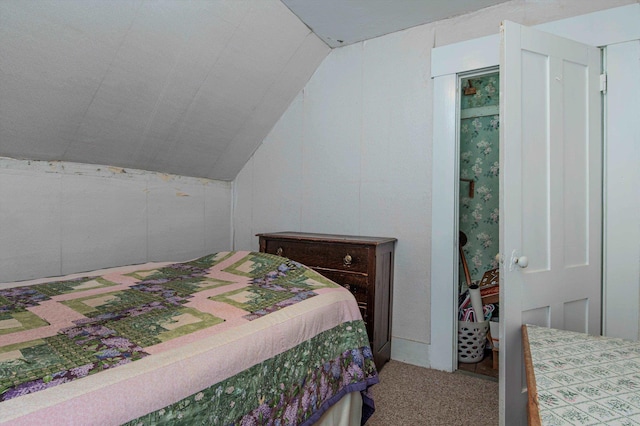 bedroom with vaulted ceiling and carpet