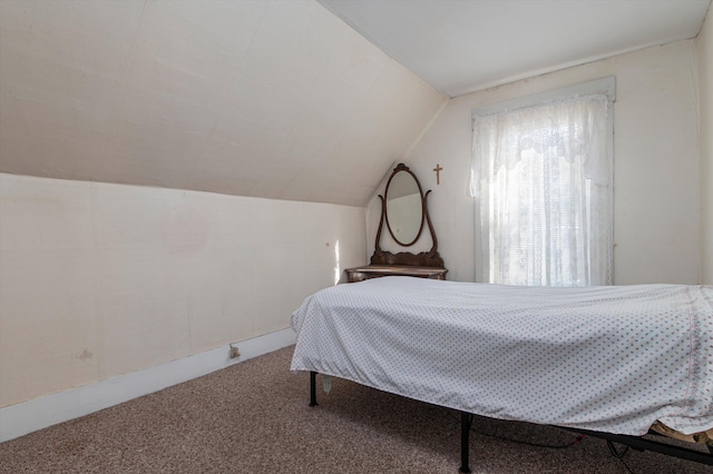 bedroom with lofted ceiling and carpet floors