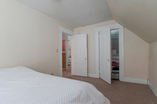 carpeted bedroom with lofted ceiling