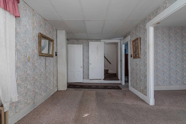 basement with carpet floors and a drop ceiling