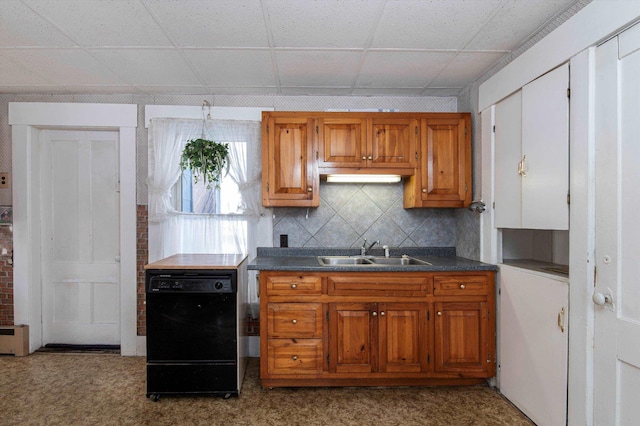 kitchen featuring sink, tasteful backsplash, dishwasher, light colored carpet, and a drop ceiling