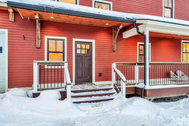 view of snow covered property entrance