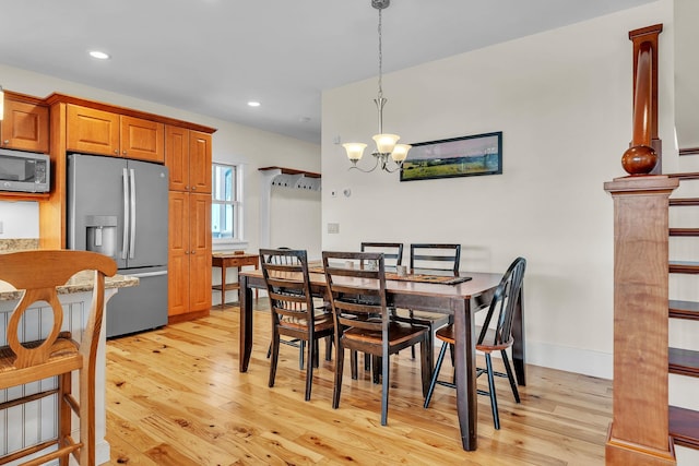 dining room with an inviting chandelier and light hardwood / wood-style floors