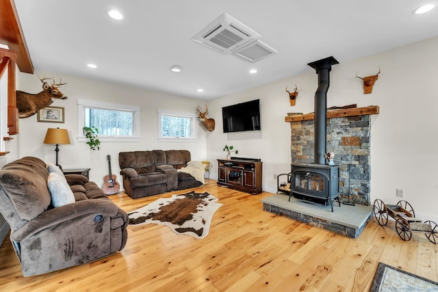 living room featuring hardwood / wood-style flooring and a wood stove