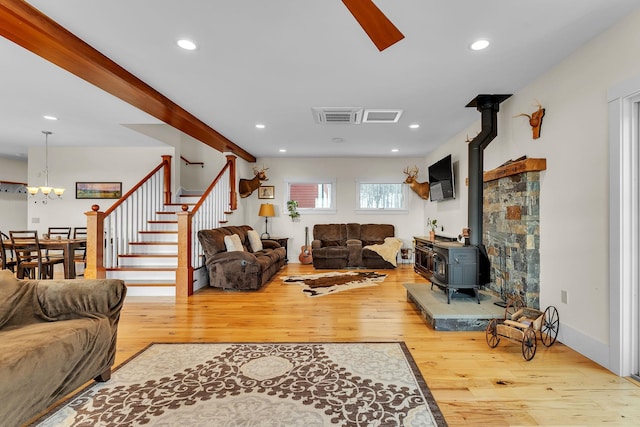 living room with hardwood / wood-style flooring and a wood stove