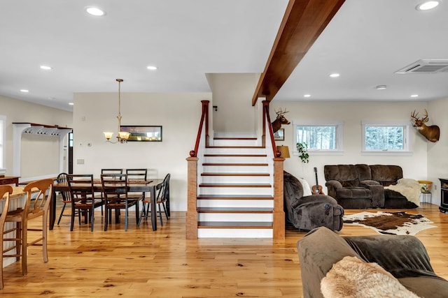 interior space featuring hardwood / wood-style flooring and an inviting chandelier