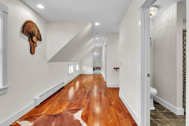 bonus room with baseboard heating, vaulted ceiling, and hardwood / wood-style floors