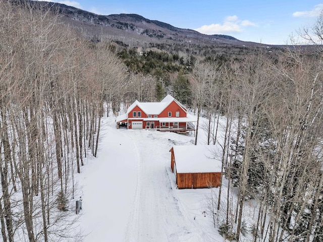 snowy aerial view featuring a mountain view