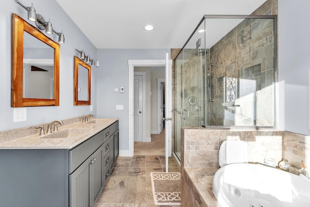 bathroom with vanity and independent shower and bath