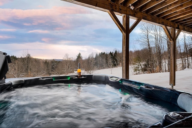 snow covered patio with a hot tub