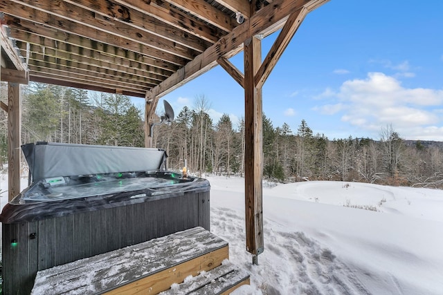 snow covered deck with a hot tub