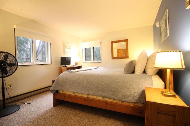 carpeted bedroom with a baseboard heating unit