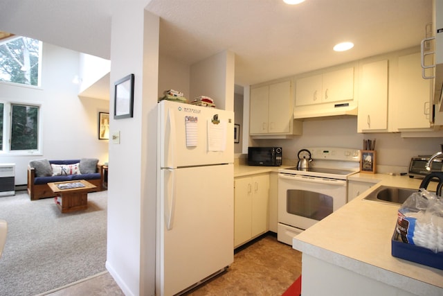 kitchen featuring white cabinetry, sink, white appliances, and light colored carpet