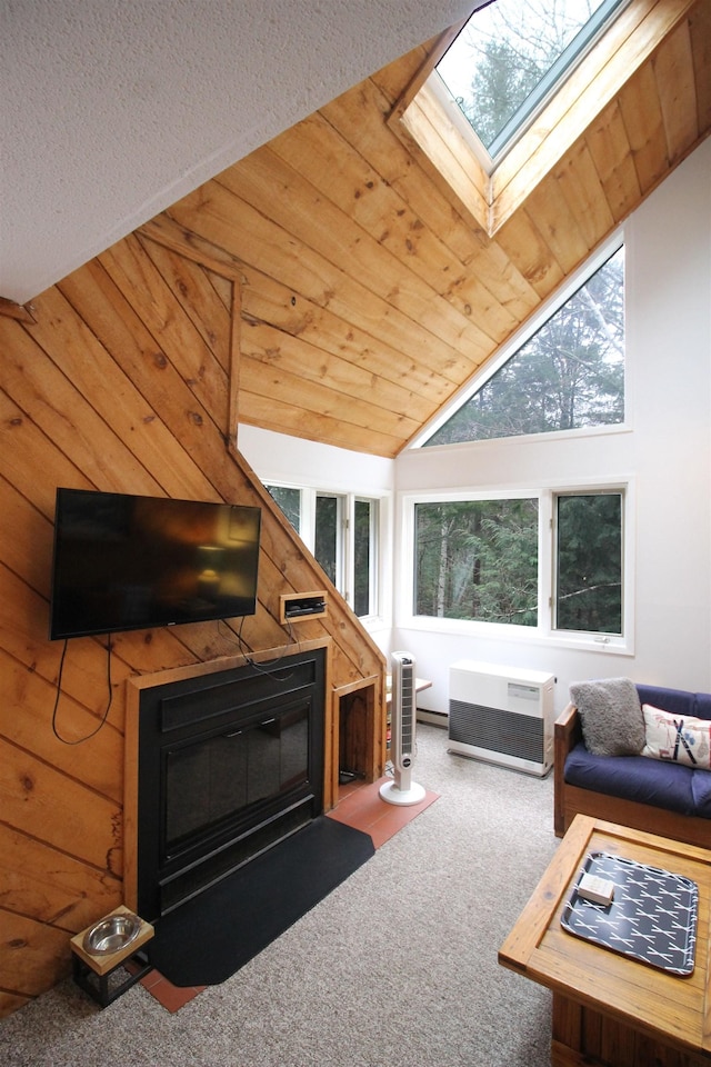 carpeted living room featuring lofted ceiling with skylight and wooden ceiling